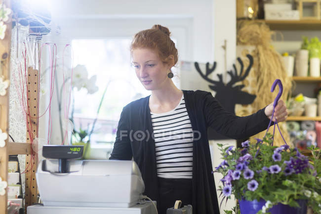 Florista mujer trabajando en tienda - foto de stock
