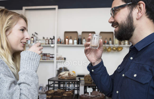 Couple drinking espresso in cafe together — Stock Photo