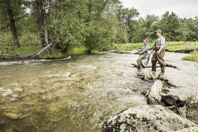 Couple in river fly fishing — Stock Photo