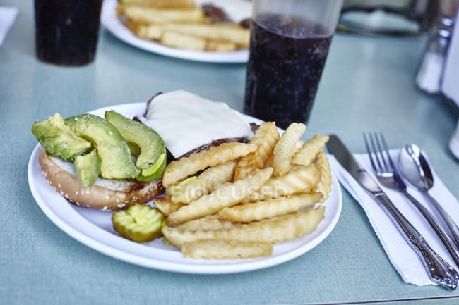 Burger and chips with cola on cafe table, New York City, USA — Stock Photo