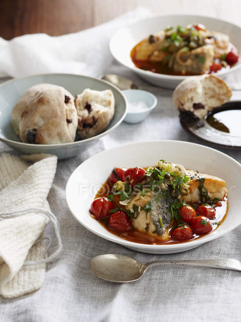 Sicilian monkfish stew and bread rolls — Stock Photo