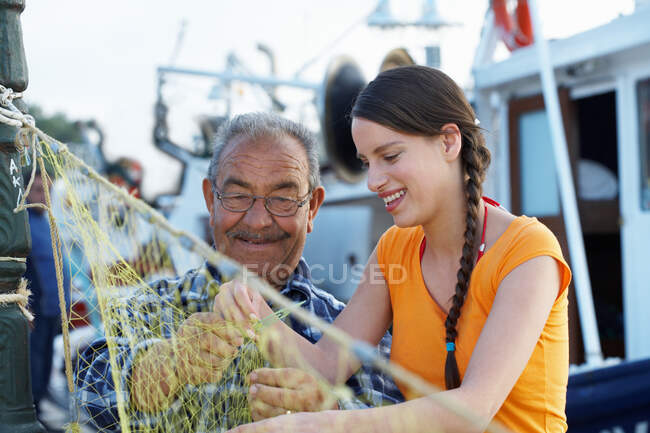 Young girl and fisherman — Stock Photo
