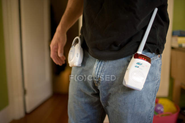 Man with baby monitor attached to jeans — Stock Photo