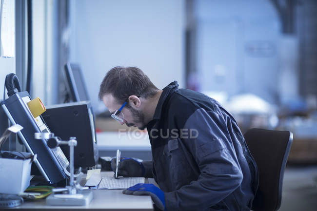 Young adult male Engineer at desk drawing — Stock Photo
