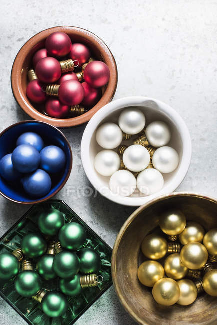 Top view of colorful Christmas baubles in bowls — Stock Photo
