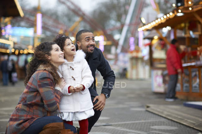 Mother and daughter in amusement park looking up smiling — Stock Photo