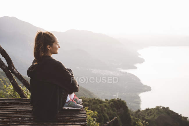Young woman on balcony looking out over Lake Atitlan, Guatemala — Stock Photo