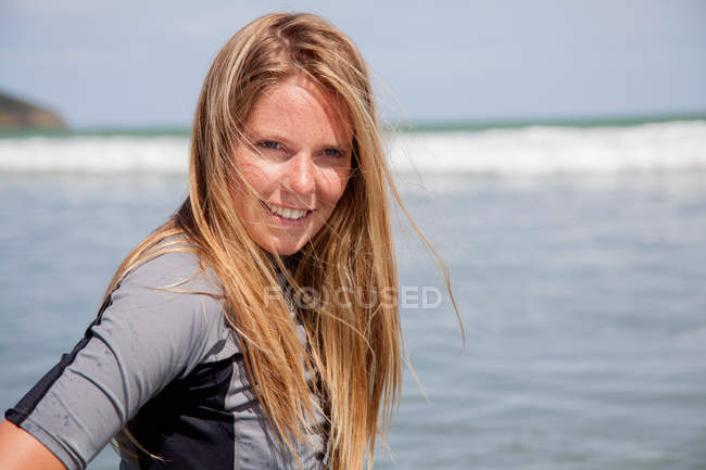 Portrait of young woman wearing wetsuit — Stock Photo