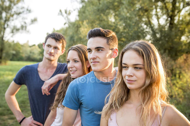 Portrait of group of friends in rural environment, smiling — Stock Photo
