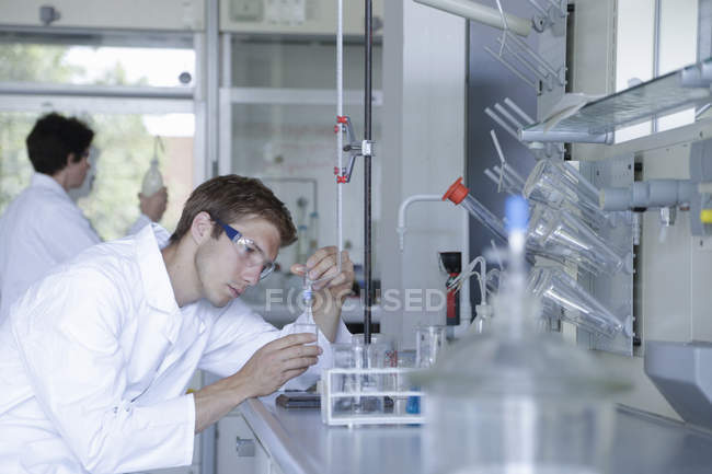 Científicos masculinos y femeninos que trabajan en laboratorio - foto de stock