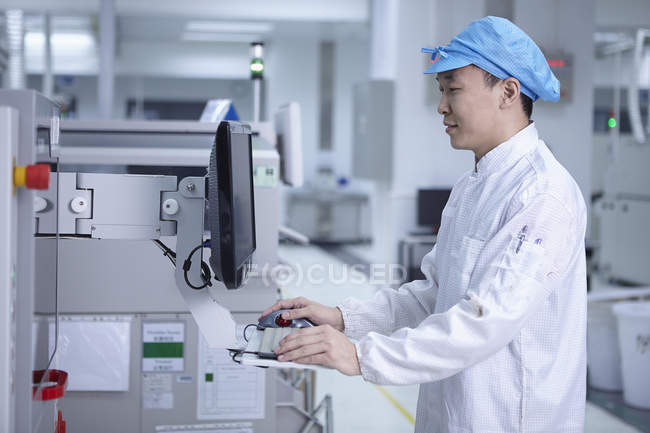 Trabalhador masculino que utiliza máquinas na fábrica de alta tecnologia — Fotografia de Stock