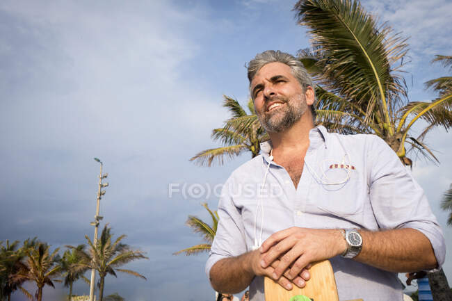 Man, palm trees in background — Stock Photo
