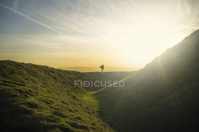 Silhouette of person standing sun lighted Malvern Hills — Stock Photo