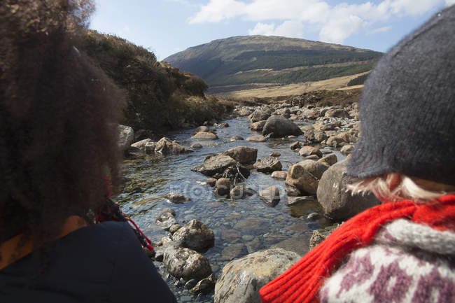 Mujer y niño mirando a la vista, Piscinas de hadas, Isla de Skye, Hébridas, Escocia - foto de stock
