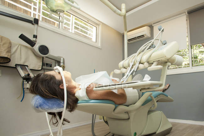 Paciente feminina aguardando terapia em cirurgia dentária — Fotografia de Stock