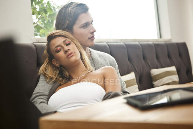 Young couple relaxing in hotel lobby — Stock Photo