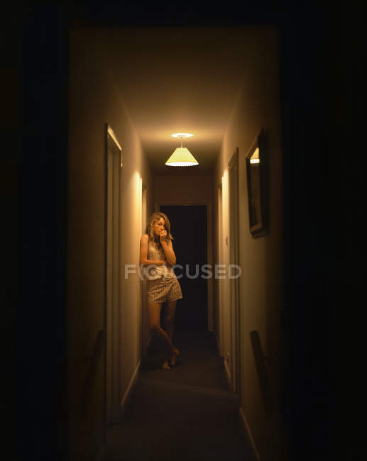 Portrait of teenage girl alone in dark corridor — Stock Photo