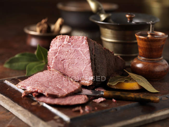 Dry cured pieced salt beef joint with orange leaves — Stock Photo