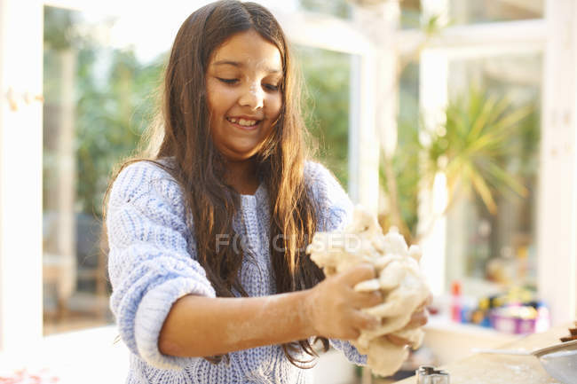 Girl making dough in kitchen — Stock Photo