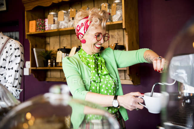Винтажная зрелая женщина, работающая в чайной — стоковое фото