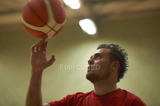Student balancing basketball on fingertips — Stock Photo
