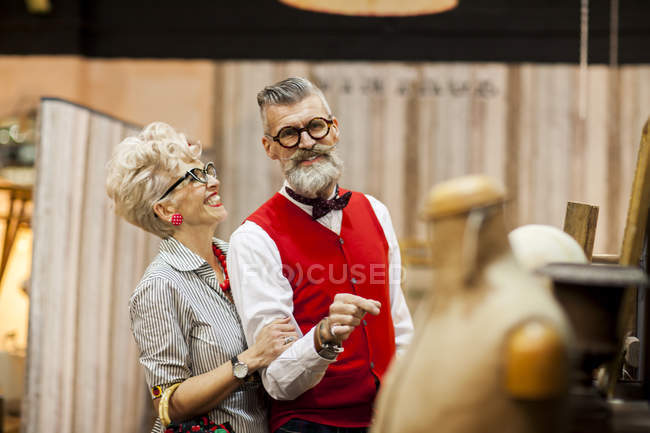 Quirky vintage couple shopping in antiques emporium — Stock Photo