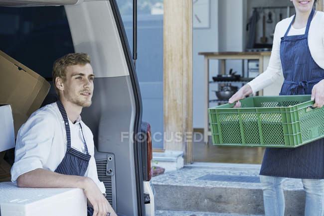 Caterers loading vehicle for preparing food — Stock Photo
