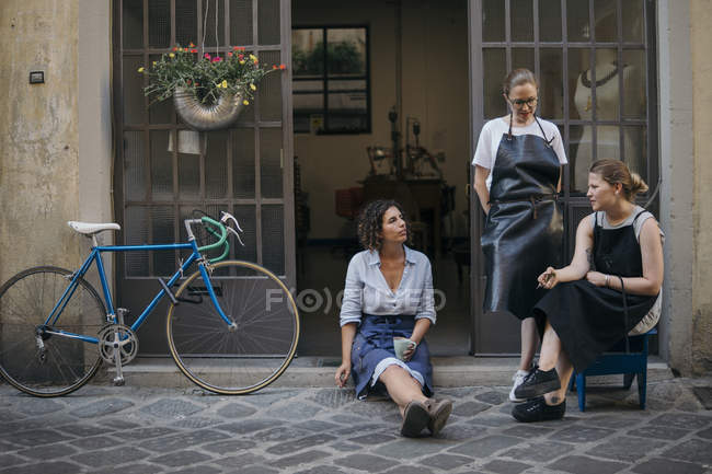 Три ювелирки берут перерыв на кофе на улице — стоковое фото