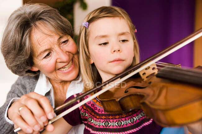 Grandma teaching grandchild music — Stock Photo