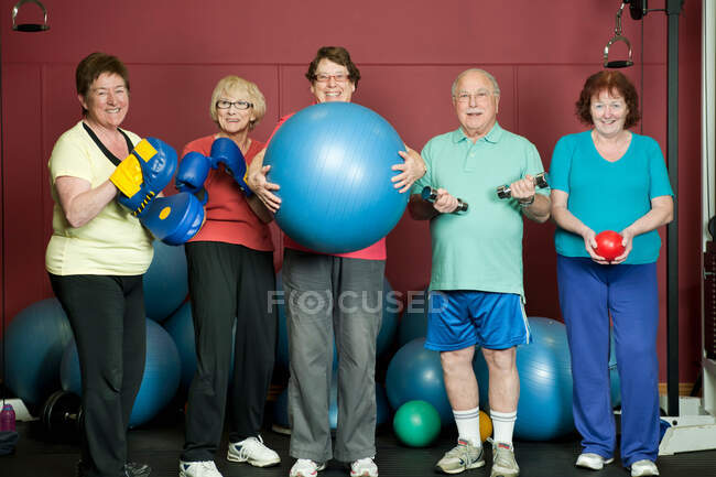 Older people with exercise equipment — Stock Photo