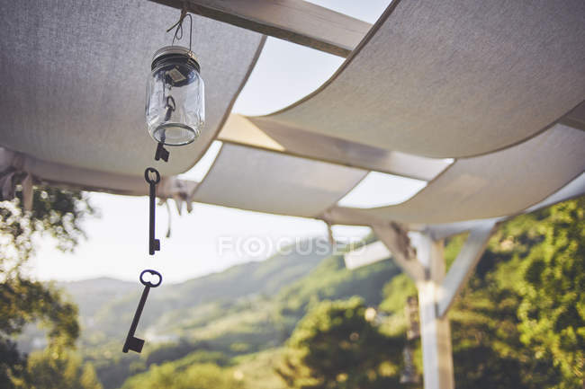 Key wind chime hanging from patio rafter, Lucca, Tuscany, Italy — Stock Photo