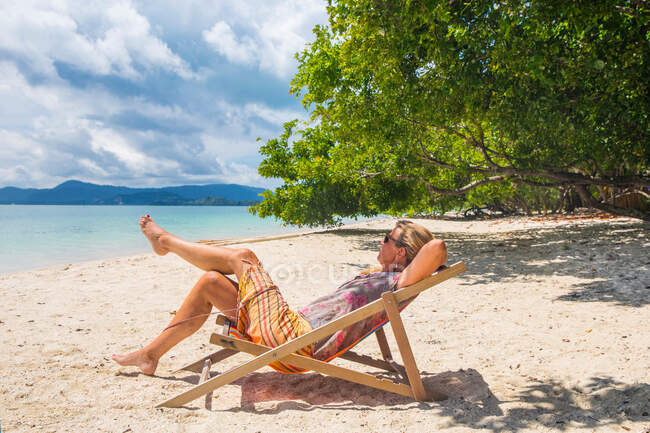 Mujer reclinada en tumbona en la playa, Koh Rang Yai, Tailandia, Asia - foto de stock