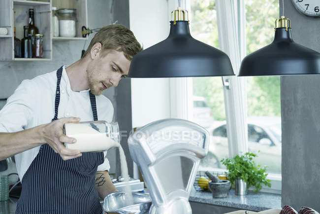 Шеф-кухар наливає інгредієнти в вінтажні ваги — стокове фото