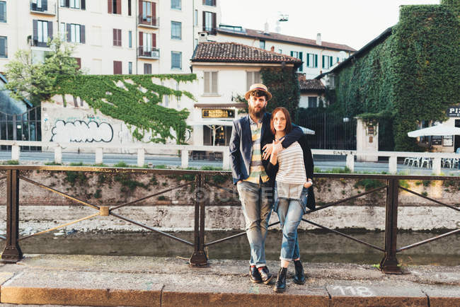 Portrait of cool couple by city canal — Stock Photo