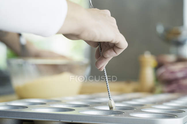Chef brushing oil onto baking tray — Stock Photo