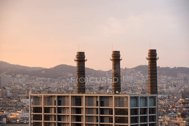 Elevated cityscape with row of smoke stacks, Barcelona, Spain — Stock Photo