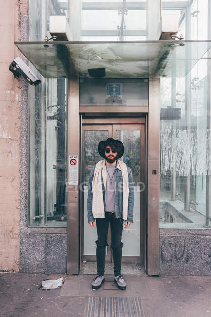 Portrait of young man standing in doorway — Stock Photo