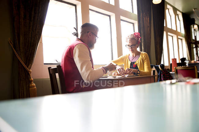 Quirky couple relaxing in bar and restaurant, Bournemouth, England — Stock Photo