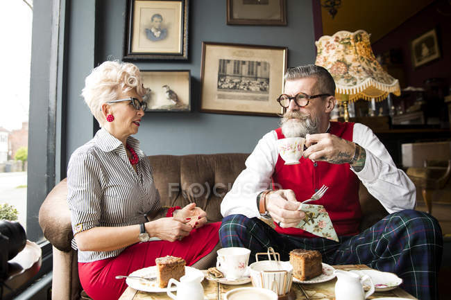 Quirky vintage couple drinking tea in tea room — Stock Photo