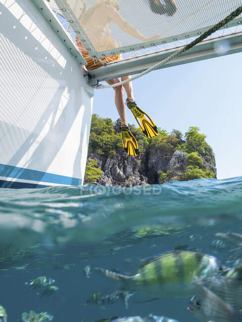 Legs of woman dangling from yacht, Koh Pak Ka, Krabi, Thailand, Asia — Stock Photo