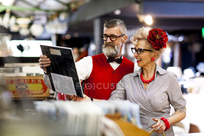 Quirky vintage couple shopping together in antiques emporium — Stock Photo