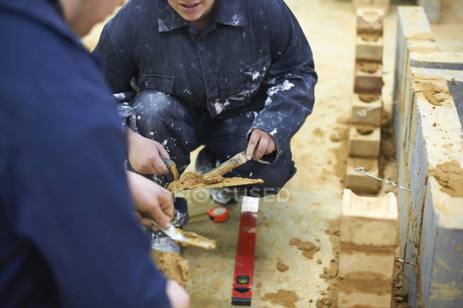 Two students practicing at building work — Stock Photo