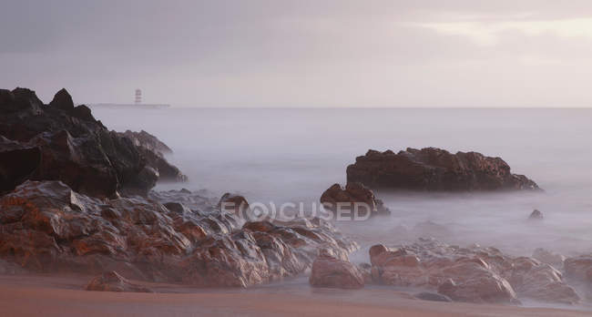 Rocky coastline at dusk — Stock Photo