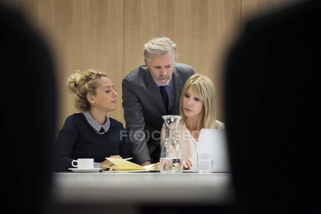 Colleagues in conference room having meeting, using laptop — Stock Photo