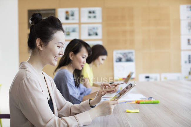 Students sitting and working side by side — Stock Photo