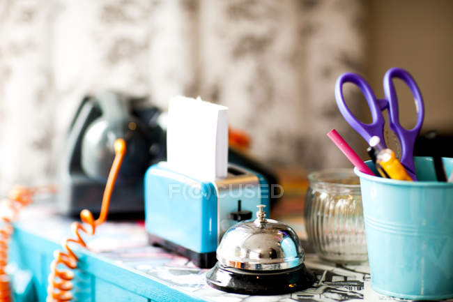 Stationery and service bell on reception desk of quirky hair salon — Stock Photo