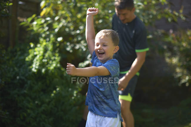 Father and son playing in garden — Stock Photo