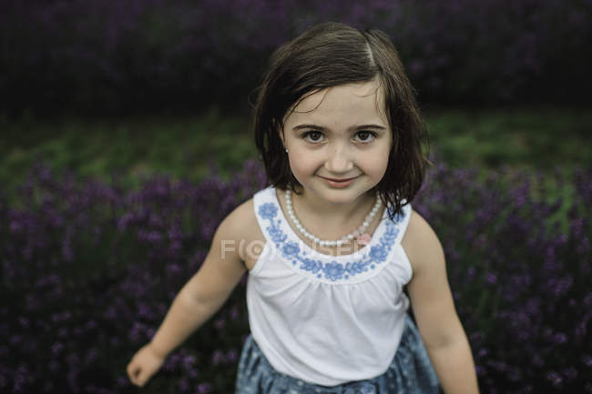 Portrait of girl standing in lavender — Stock Photo
