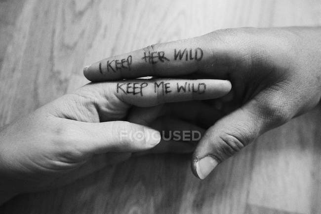 Couple, hands touching, writing on index fingers, close-up — Stock Photo