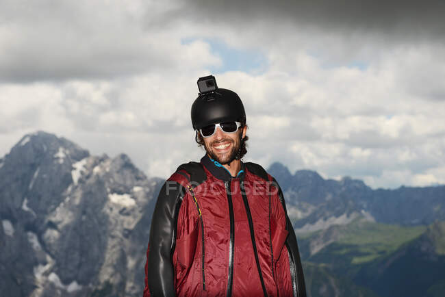Portrait of base jumper wearing wingsuit with action camera on helmet, Dolomite mountains, Canazei, Trentino Alto Adige, Italy, Europe — Stock Photo